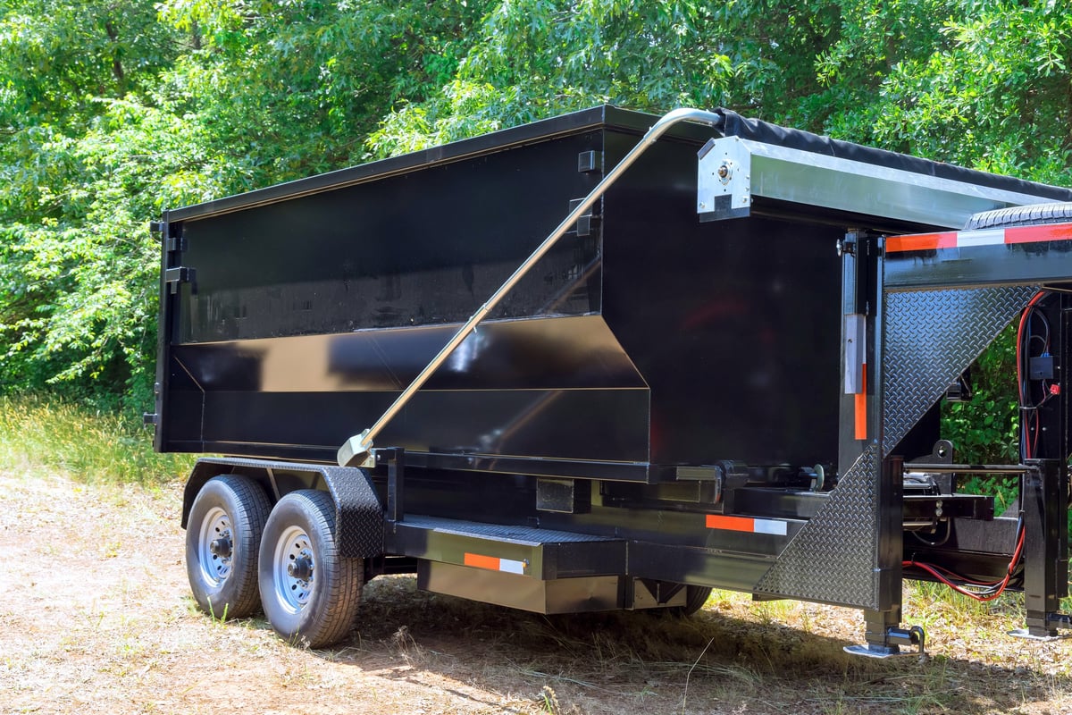 Truck unloading a container of hauled debris
