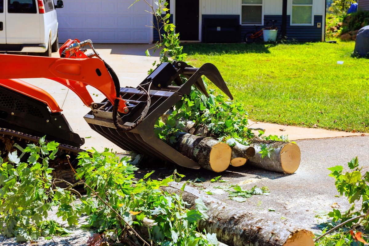 Equipment clearing debris from a residential driveway in Northeast Arkansas