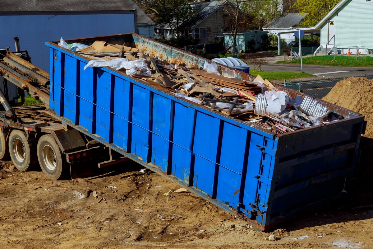 Truck being loaded with junk and hauling debris